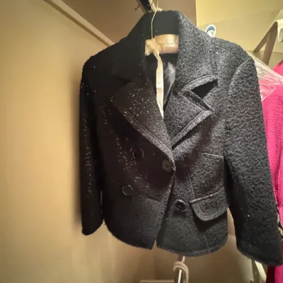 Black textured wool-blend double-breasted jacket featuring subtle sequin embellishments on the lapel and front panel.