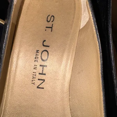 Close-up of the leather insole of a St. John shoe, showing the brand name and "Made in Italy" stamp.