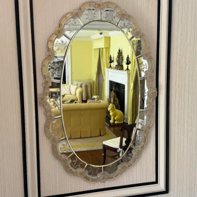 Vintage Venetian-style oval glass mirror featuring an etched floral border, mounted on a custom cream and black framed backing.