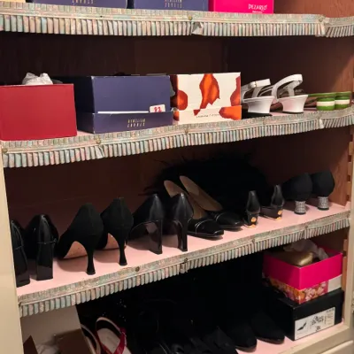 A collection of women's designer shoes and shoeboxes, including brands like Stuart Weitzman and Donald J Pliner, organized on...