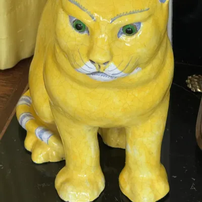 Vintage Italian ceramic yellow cat figurine featuring a crackle glaze finish, green eyes, and hand-painted details.