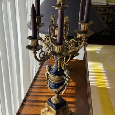 Ornate French Empire style five-light candelabra featuring a cobalt blue porcelain urn body with gilt bronze mounts, cherub handles, and...