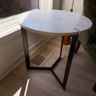 Round white marble-top side table, black base