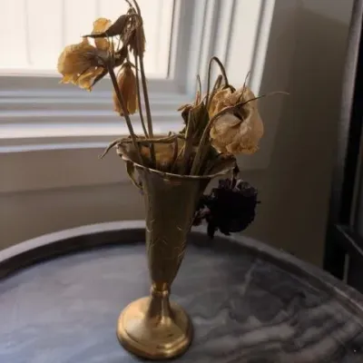 Brass trumpet vase with dried flowers