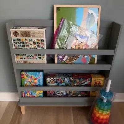 Gray kids book display shelf with puzzles