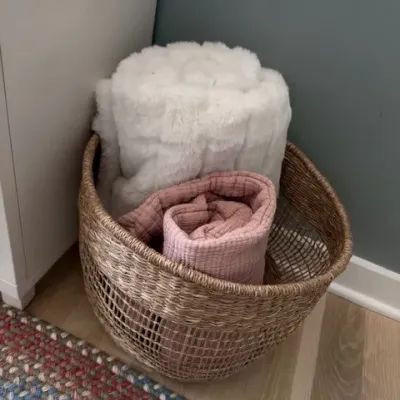 Woven storage basket with throw blankets