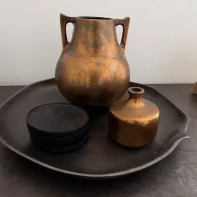 Metallic bronze vases and black decorative tray