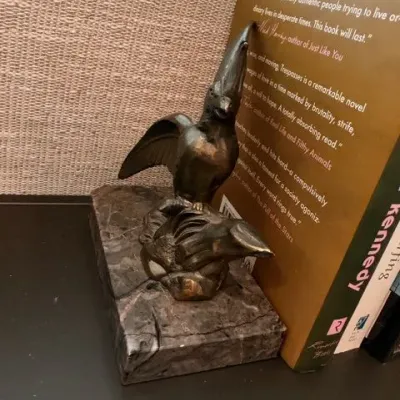 Bronze-tone bird bookend on marble base