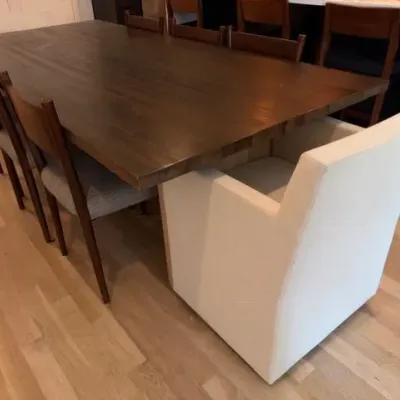 Dark wood dining table with side chairs and RH Ellison end chairs