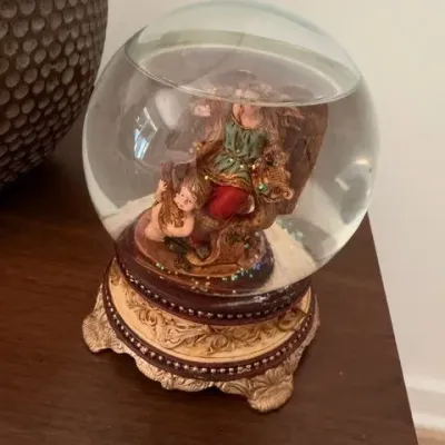 Decorative snow globe on ornate gold base
