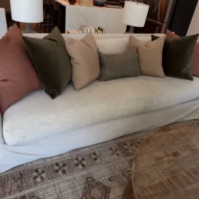 White slipcovered sofa with throw pillows