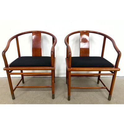 Pr BRUETON INDUSTRIES Ming style Mahogany Armchairs. Brass foot caps. Black upholstery. Label.