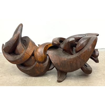 Large scale abstract hand carved wood sculpture. Interlocking organic curvilinear forms. Dark brown