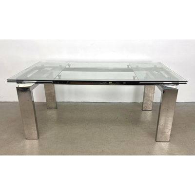 Modern polished chrome and glass extendable dining table with lateral leaves and block legs. Unmarke