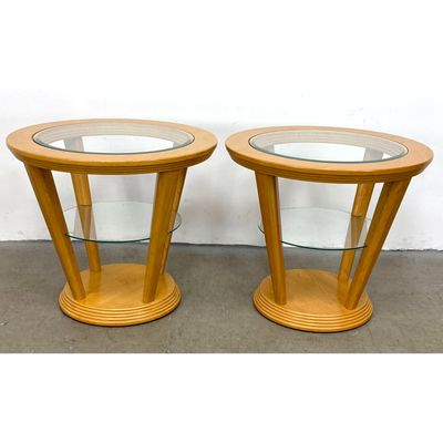 Pair contemporary light wood and glass round tiered side tables with splayed legs and stepped bases.