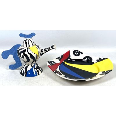 Two piece contemporary ceramic teapot and bowl with bold polychrome Memphis style patterns.