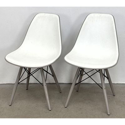 Pair of Eames style white polypropylene molded side chairs with gray painted legs and black wire bra
