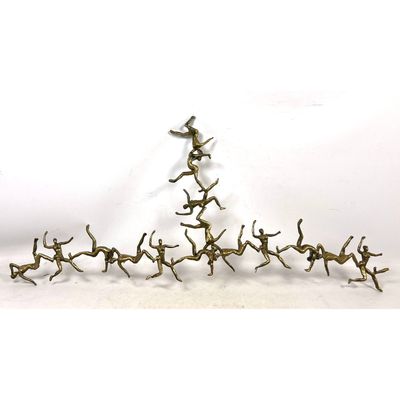 Falling People wall Sculpture. Gold finished cast aluminum.