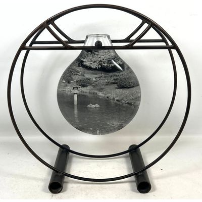 Art Glass and Iron Table Sculpture.  Thick Glass bottle form center has photograph film inside and O