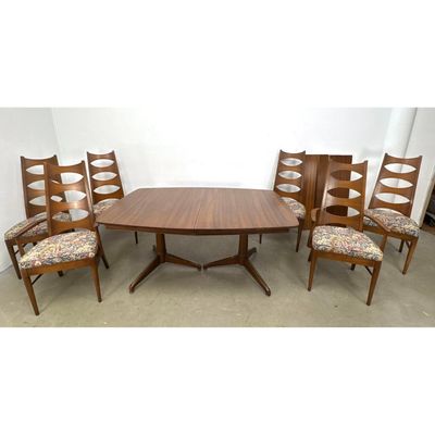 Mid-Century Modern walnut dining room set featuring a boat-shaped extension table with 2 leaves and