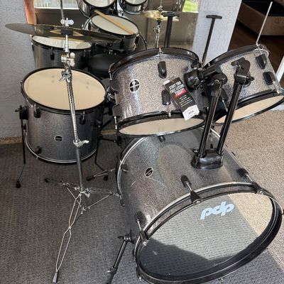 PDP Player 5-piece drum set in a silver sparkle finish, including a bass drum, floor tom, two rack toms, a snare drum, and a cymbal stand.