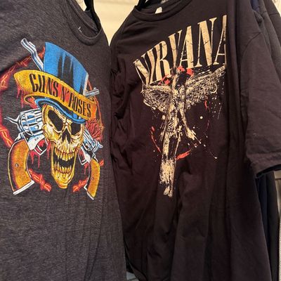 Two graphic band t-shirts featuring a grey Guns N' Roses skull design and a black Nirvana 'In Utero' angel design.
