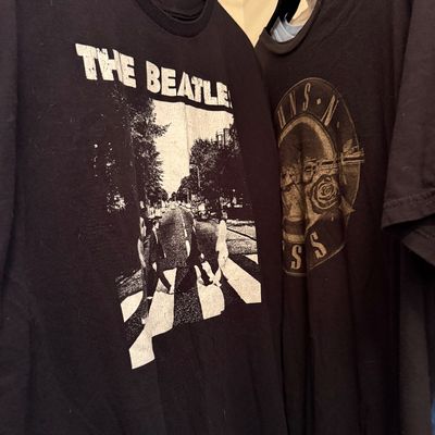 Two black graphic band t-shirts, featuring The Beatles' Abbey Road album cover and a Guns N' Roses logo.