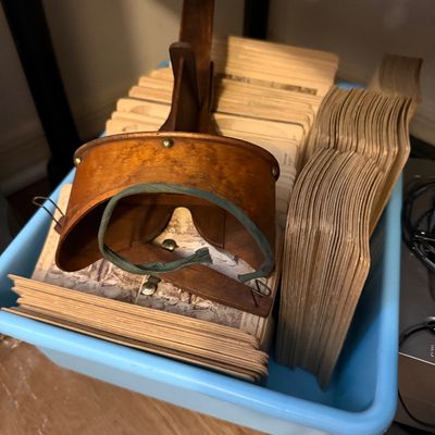 Antique wooden stereoscope viewer with a large collection of vintage stereoview cards