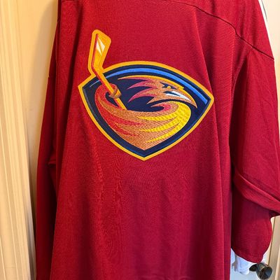 Vintage Atlanta Thrashers red hockey jersey featuring the team's crest logo on the front.