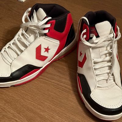 Pair of Converse high-top basketball sneakers in a white, red, and black colorway, showing light wear.
