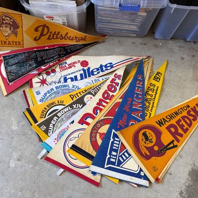 Collection of vintage sports and souvenir felt pennants, including Pittsburgh Pirates, Washington Bullets, New York Rangers, and...
