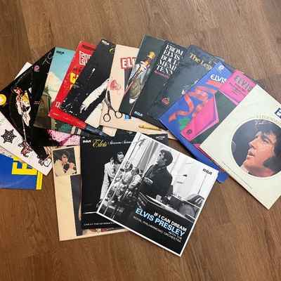 Collection of vintage Elvis Presley vinyl record albums, showing various cover designs and titles from his career.