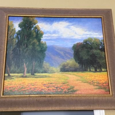 Framed landscape oil painting depicting a dirt path winding through a field of orange wildflowers, flanked by eucalyptus and oak trees...
