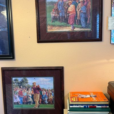 Two framed vintage-style golf prints depicting historical golf scenes with spectators, presented in dark wood frames with double matting.