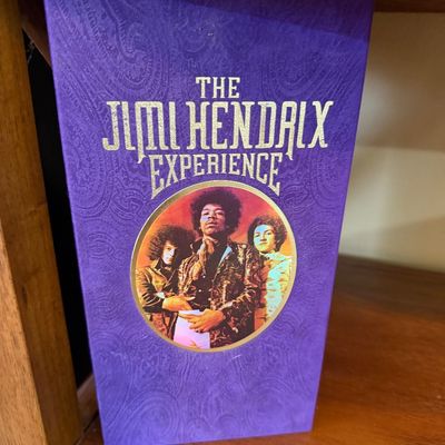 "The Jimi Hendrix Experience" purple velvet box set, featuring a paisley pattern and a circular band portrait on the front cover.