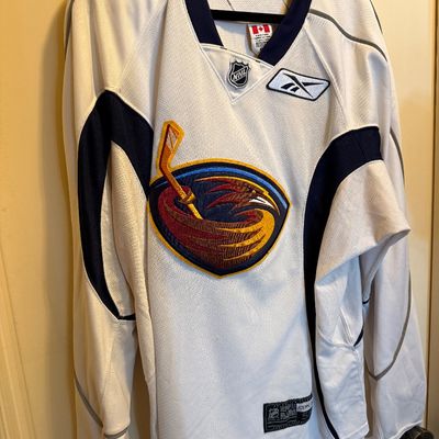 Vintage Reebok Atlanta Thrashers NHL hockey jersey in white, size 50, featuring embroidered team crest and NHL shield.