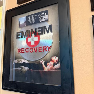 Eminem "Recovery" RIAA-style platinum record award presented to Marshall Mathers, housed in a black frame.