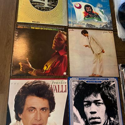 Collection of vintage vinyl records including albums by The 4 Seasons, Cat Stevens, Stephen Stills, James Taylor, Frankie Valli, and Jimi...