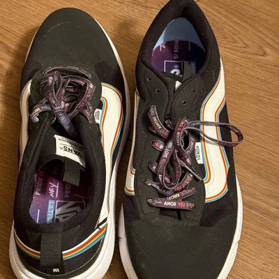 Vans UltraRange EXO Pride sneakers in black, featuring rainbow side stripes and patterned laces with multilingual words for love.