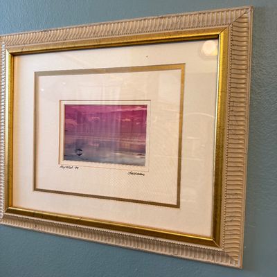Framed photograph of a Key West sunset, dated '99 and signed by Sullivan, presented in a double-matted gold and cream textured frame.