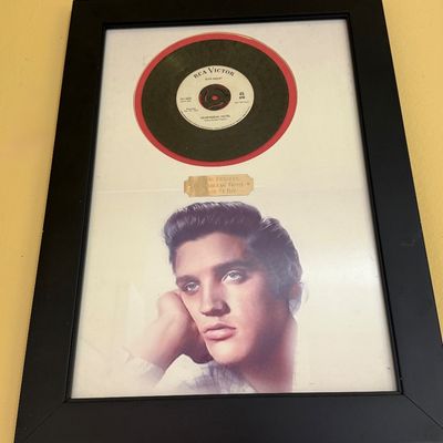Framed Elvis Presley memorabilia featuring a 45 RPM record of "Heartbreak Hotel" on the RCA Victor label, a commemorative...