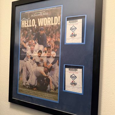 Framed Tampa Bay Rays memorabilia featuring a St. Petersburg Times front page celebrating the 2008 American League Championship,...