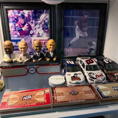 Collection of sports memorabilia including framed baseball photos, an Inside the NBA bobblehead set, Elvis-themed NASCAR die-cast cars,...