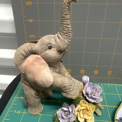 Four piece figurine set - elephant with flower. “Where’s my mom,”? Hummingbird on stained glass with hibiscus. Two cast castle, Hydro...