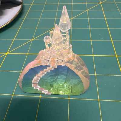 Four piece figurine set - elephant with flower. “Where’s my mom,”? Hummingbird on stained glass with hibiscus. Two cast castle, Hydro...
