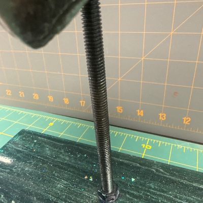 Plastic megalodon tooth replica with glittered resin stand