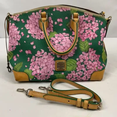 Dooney & Bourke hydrangea print satchel handbag in green and pink, featuring tan leather trim, dual top handles, and a matching...