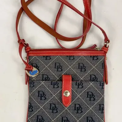 Dooney & Bourke crossbody bag featuring a blue and white signature DB monogram canvas with red leather trim and strap.
