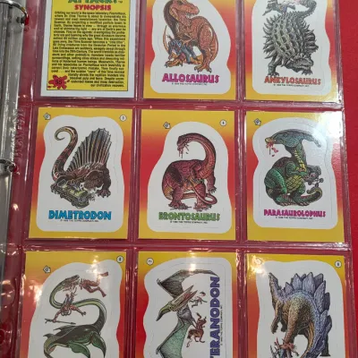 Sale Photo Thumbnail #13: Collection of 1988 Topps Dinosaurs Attack! trading cards and stickers, housed in a plastic binder sleeve.