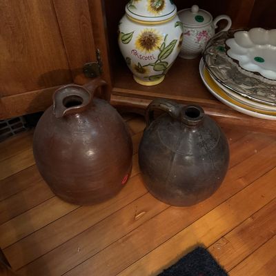 Two stoneware jugs with dark brown glazes, 